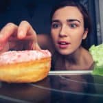 Woman reaching for donut