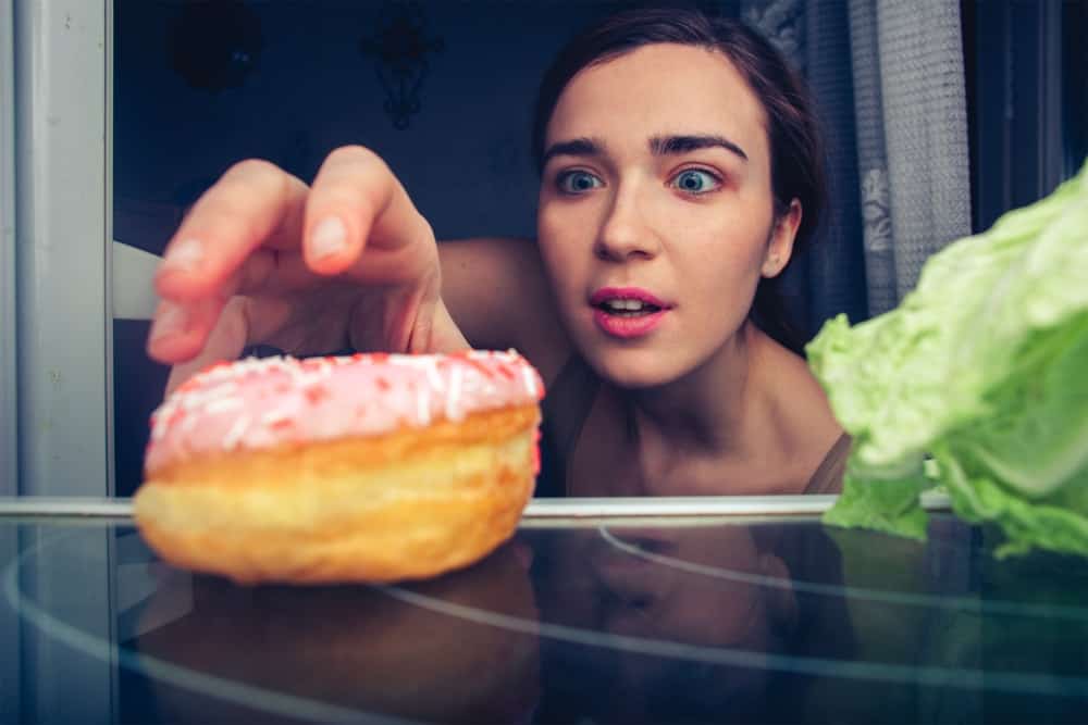 Woman reaching for donut